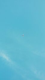 Low angle view of airplane in blue sky