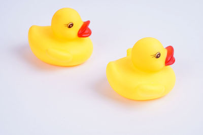 Close-up of yellow toy over white background