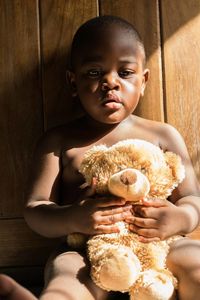 Close-up portrait of cute baby boy sitting at home