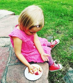 High angle view of girl eating food outdoors