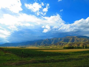 Scenic view of mountains against cloudy sky