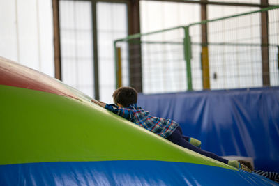 Boy playing on leather mat