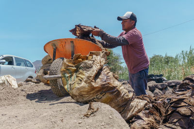 Rear view of man working at beach