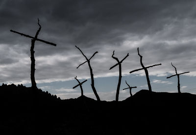 Low angle view of silhouette bare trees against sky