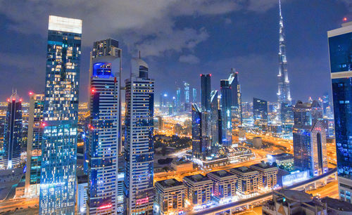 Aerial view of illuminated buildings in city at night