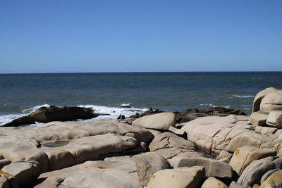 Scenic view of sea against clear blue sky