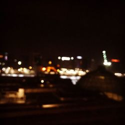 Defocused image of illuminated city at night