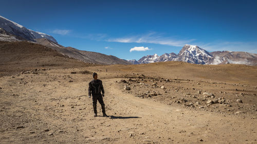 Rear view of woman standing on land