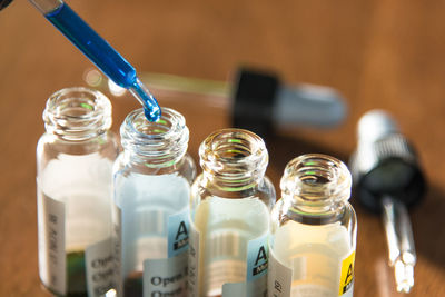 Close-up of medical sample dripping in bottle on table