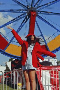 Low angle view of woman standing against the sky