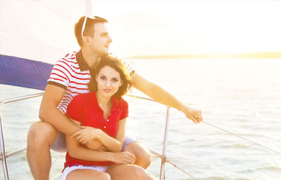 Woman sitting in boat against sea