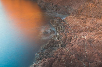 Rock formation in sea against sky