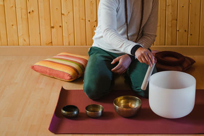 Midsection of woman sitting on table