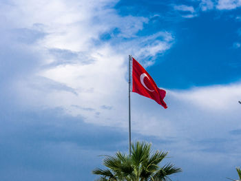 Low angle view of flag against sky