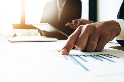 Cropped image of business people working in office