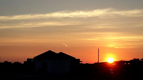 Buildings against sky at sunset