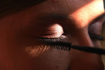 Close-up of woman applying mascara