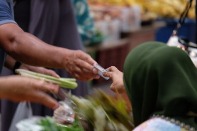 Customer giving money to vendor