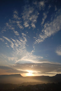 Scenic view of silhouette mountains against sky at sunset