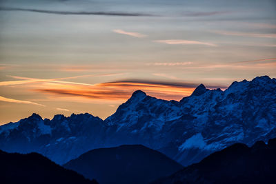 Scenic view of snowcapped mountains against sky during sunset