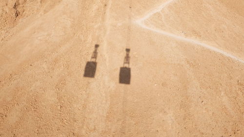Shadow of overhead cable cars at desert