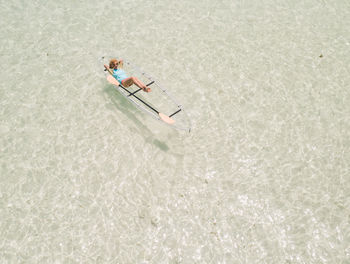 High angle view of woman on inflatable boat in sea