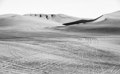 Shadow of woman on sand at beach