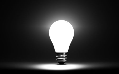 Close-up of light bulb against black background