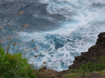 High angle view of waves splashing in sea