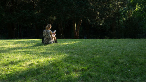 Two men sitting on grass