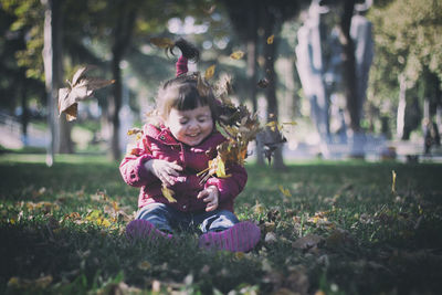 Portrait of cute girl sitting on land