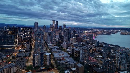 High angle view of illuminated buildings against sky in city