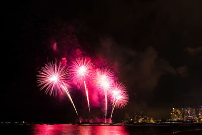 Low angle view of firework display at night