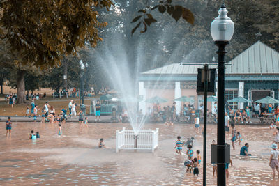 Group of people at fountain in city