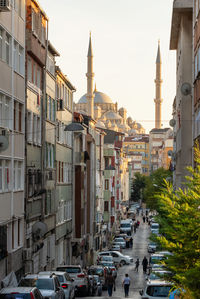 Traffic on road amidst buildings in city