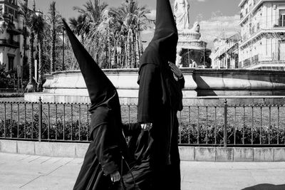 Penitente people wearing traditional clothing walking on street