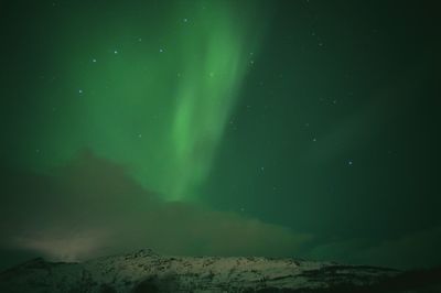 Scenic view of landscape against sky at night during winter