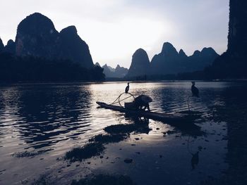 Scenic view of lake with mountains in background