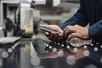 Businessman using smart phone at industry