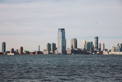 City at waterfront against sky