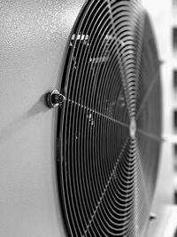 Close-up of electric fan against wall