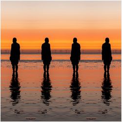 Silhouette people on beach during sunset