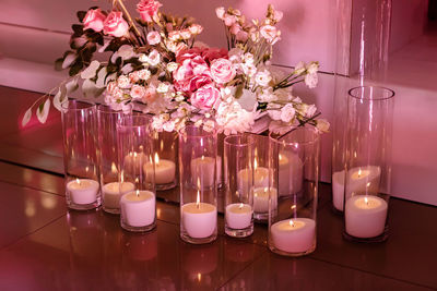 Close-up of illuminated candles on table