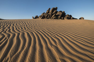 Amazing pattern and lines in sunset with rocks in the background in the desert