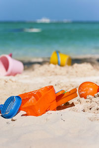 Close-up of beach against blue sky