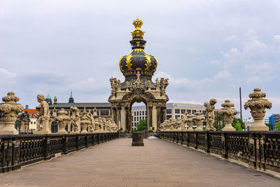 Statue of historic building against cloudy sky