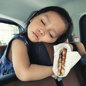 Cute girl sitting in car