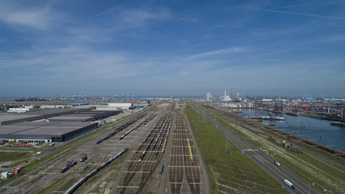 High angle view of sea by city against sky