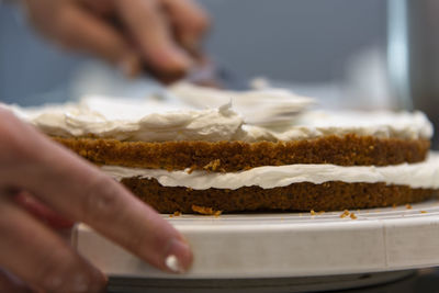 Midsection of person preparing cake