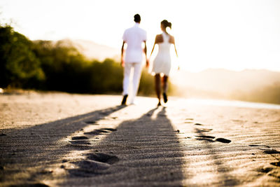 Rear view of people walking on footpath